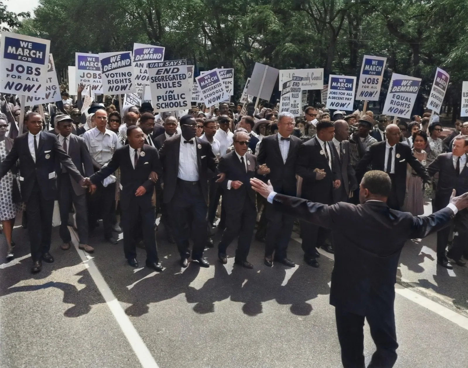 MLK leading a crowd of Black men with signs