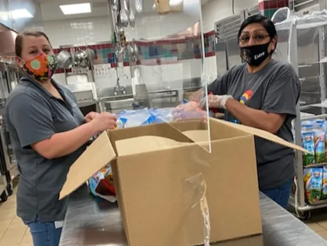 Cafeteria women wearing masks working