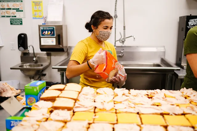 Young woman with mask in cafeteria