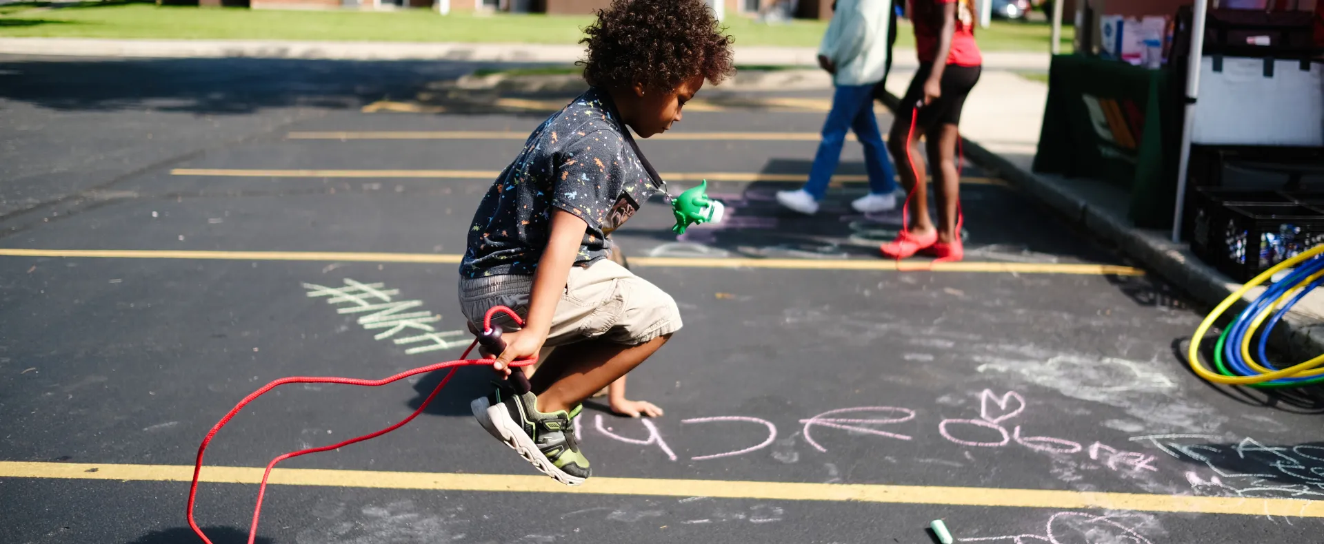 Kid jumping rope at a summer meal site.
