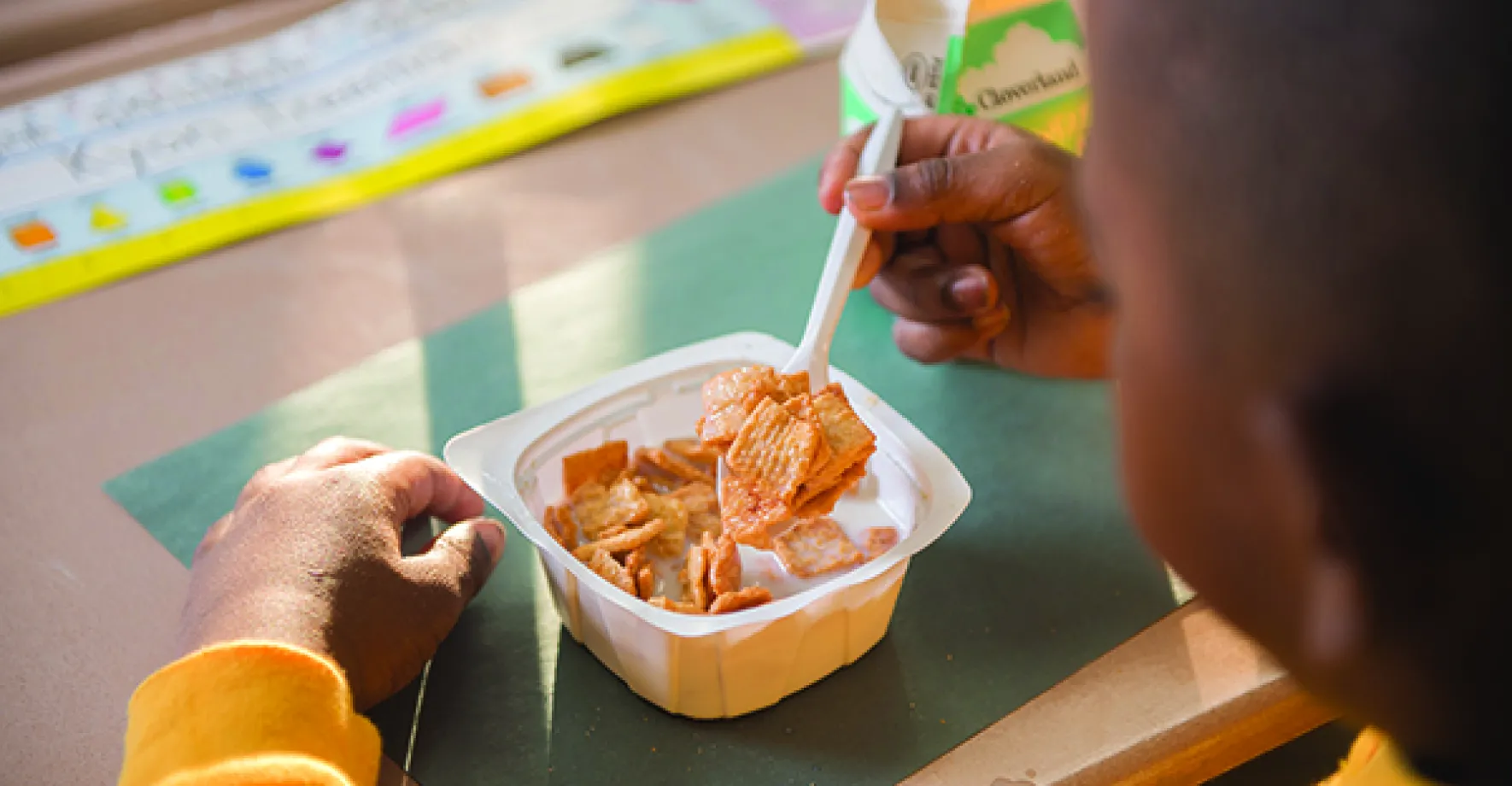 child eating breakfast at school