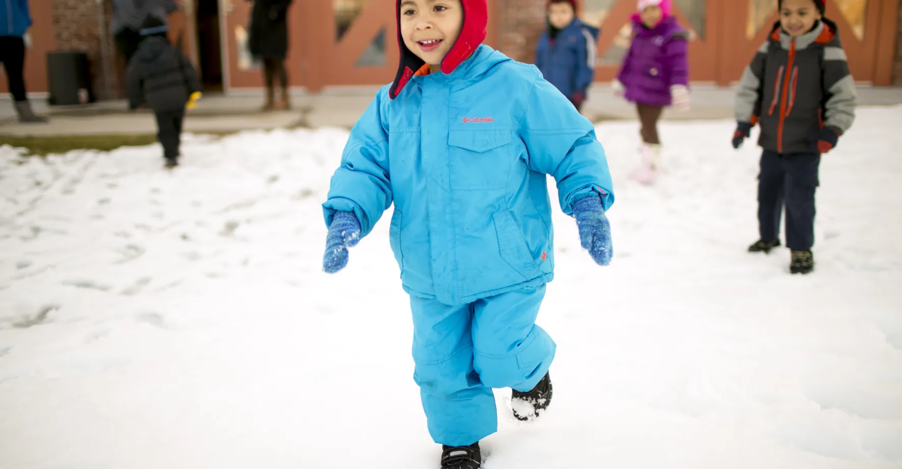 boy running in the snow