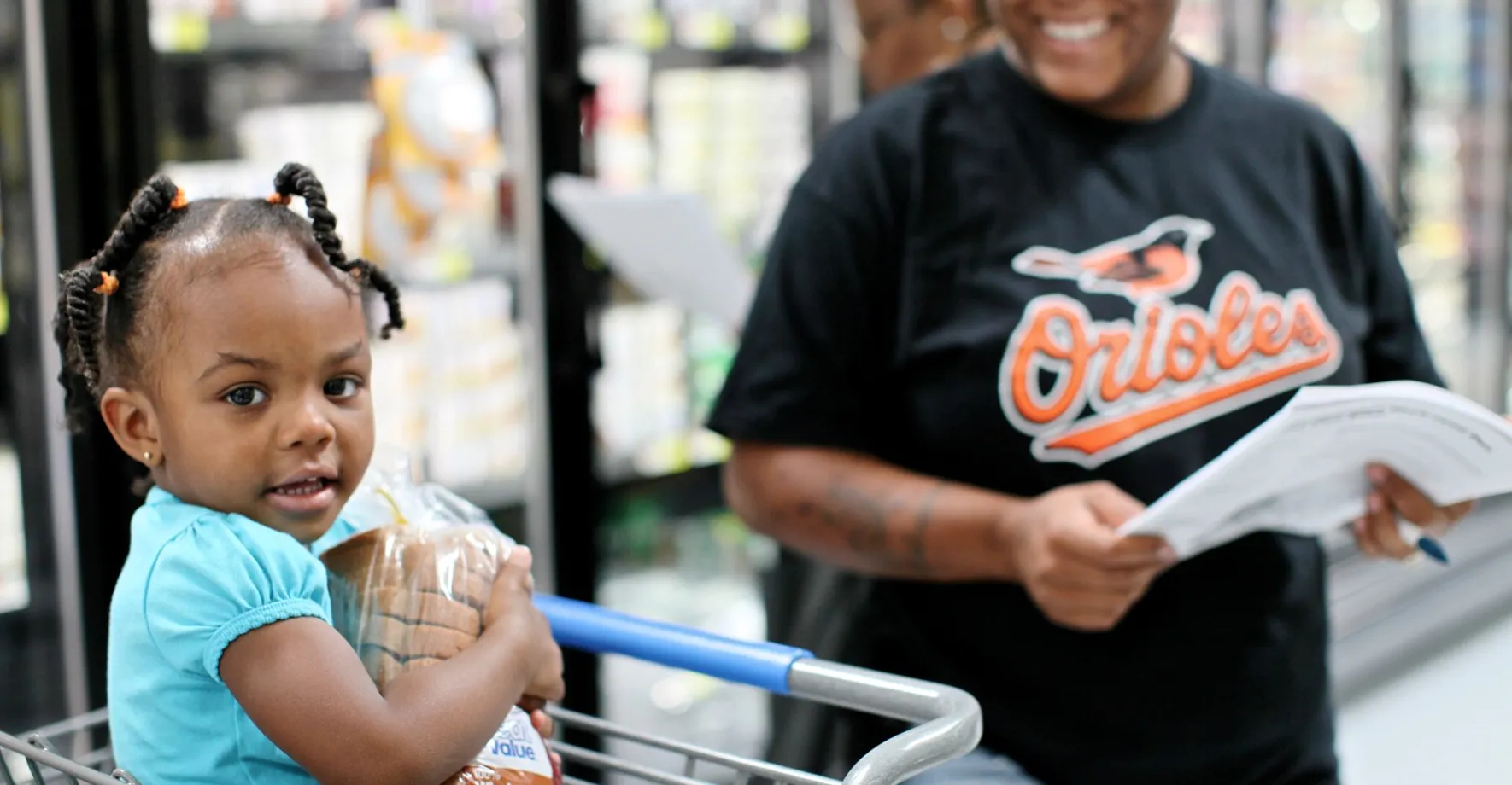 mom and child shopping at grocery store