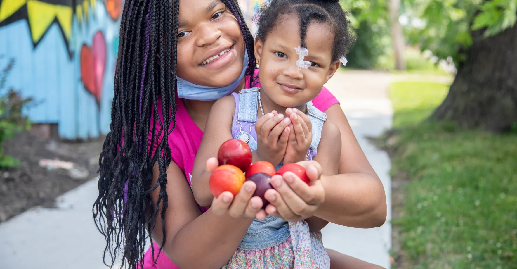 Black Mother and Daughter with Masks and Apples in Michigan