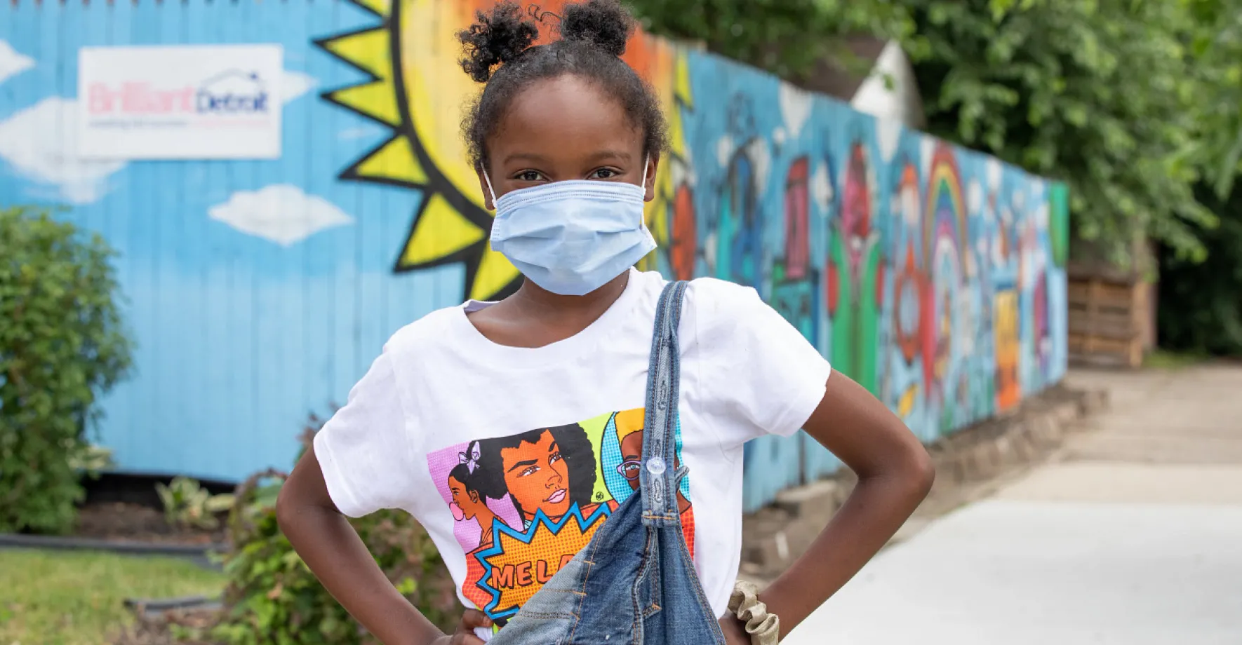 Black girl wearing as mask with hands on hips