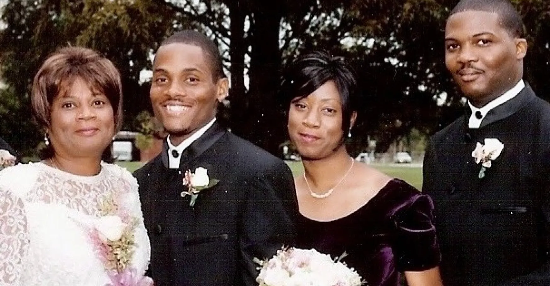 Wedding picture of man and woman accompanied by other two family members (another man and women)