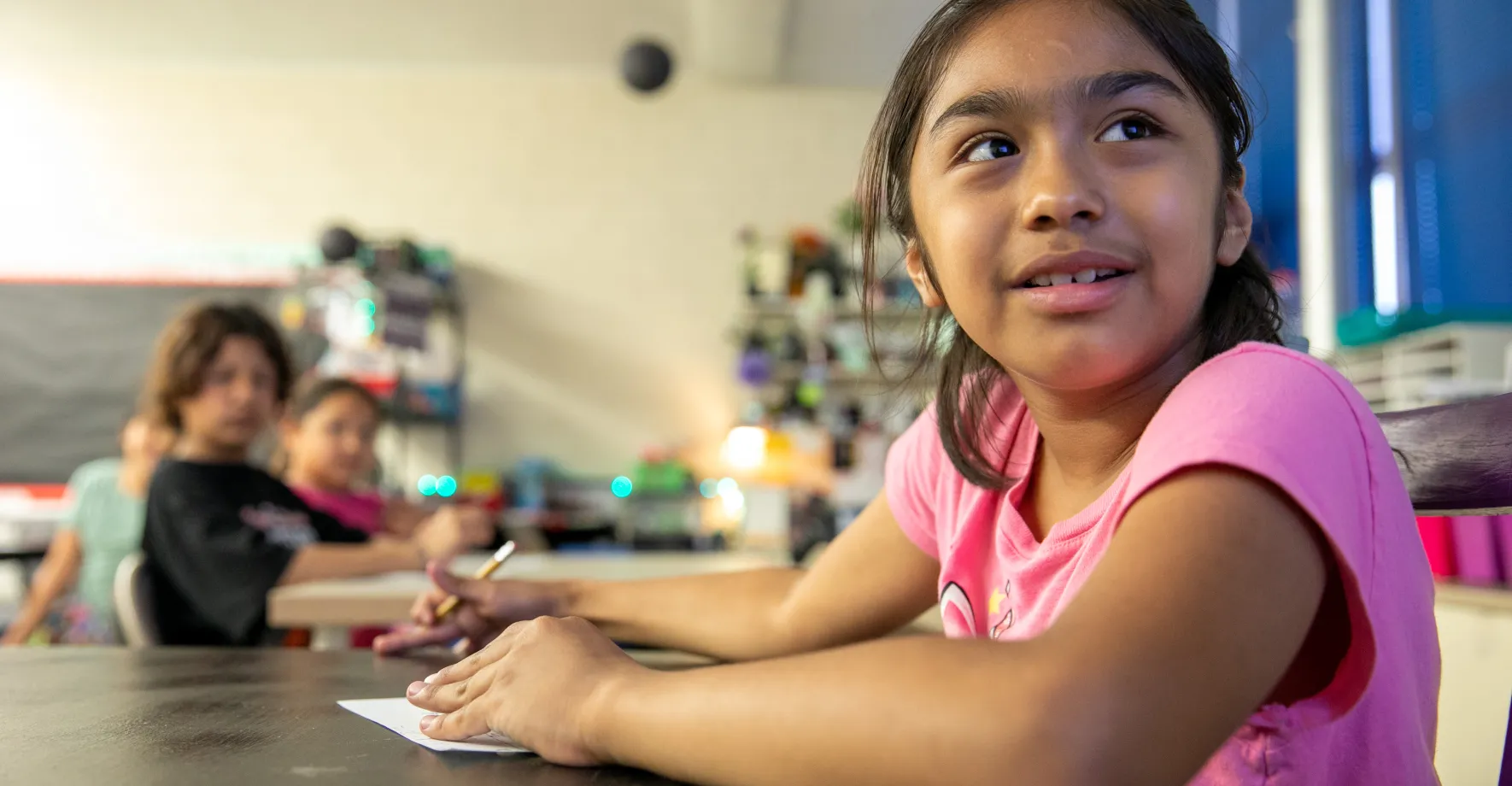 Latino girl in classroom paying attention