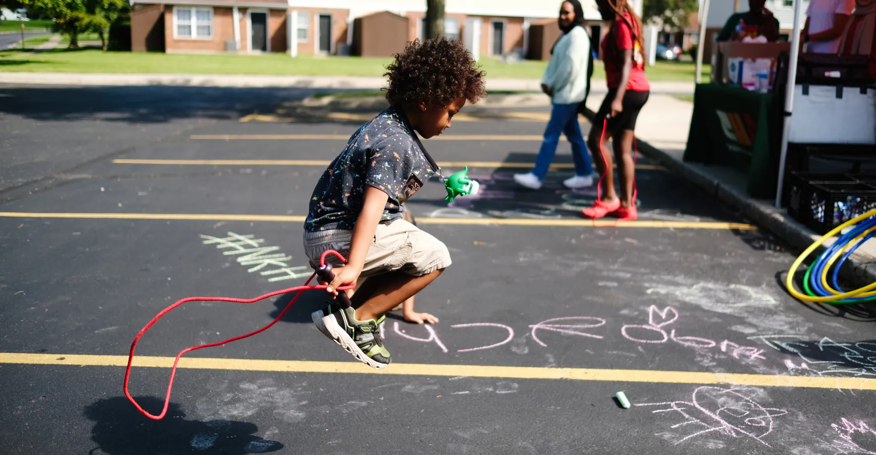 Kid jumping rope at a summer meal site.