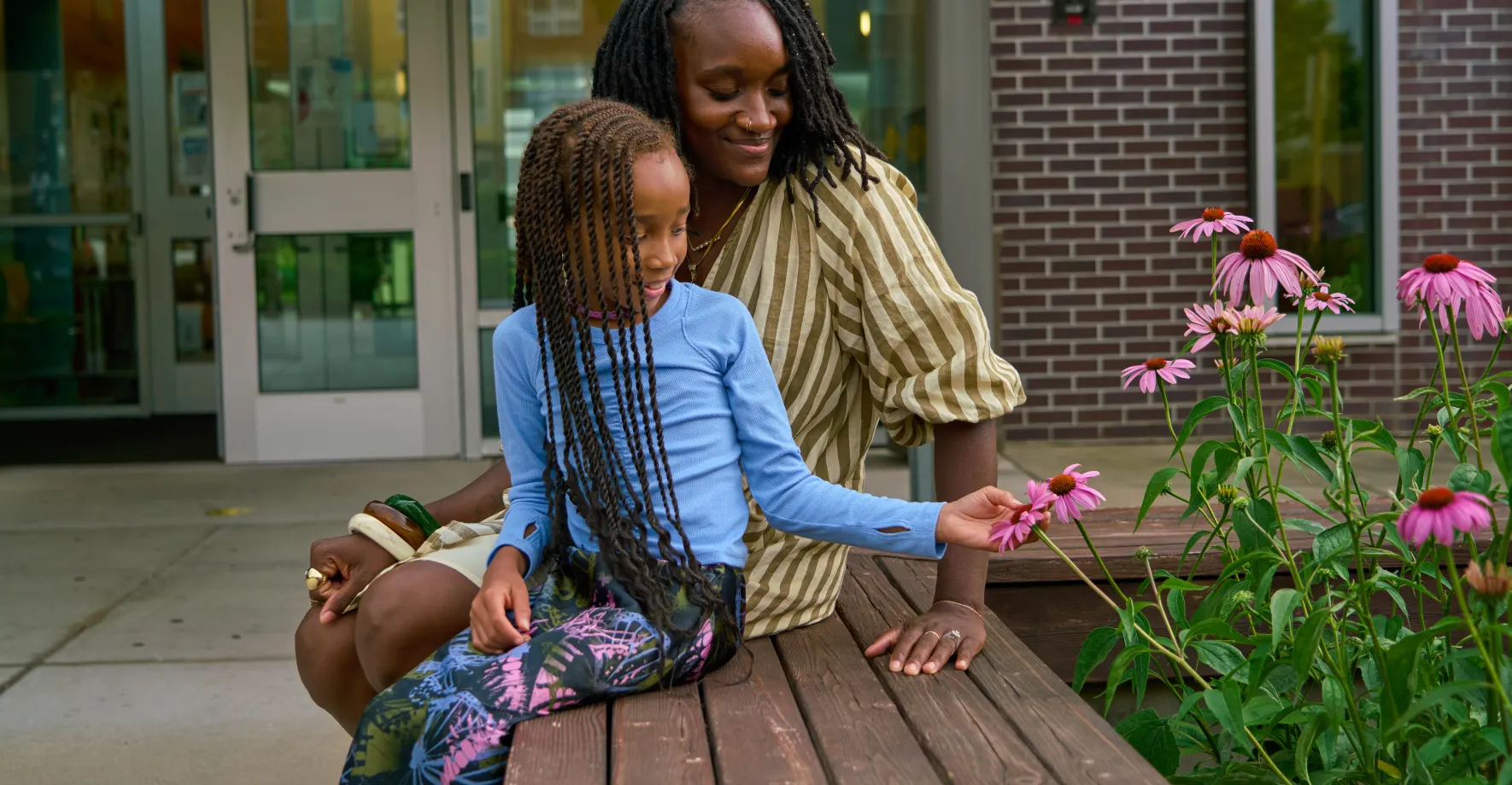 Mom and girl looking at flowers