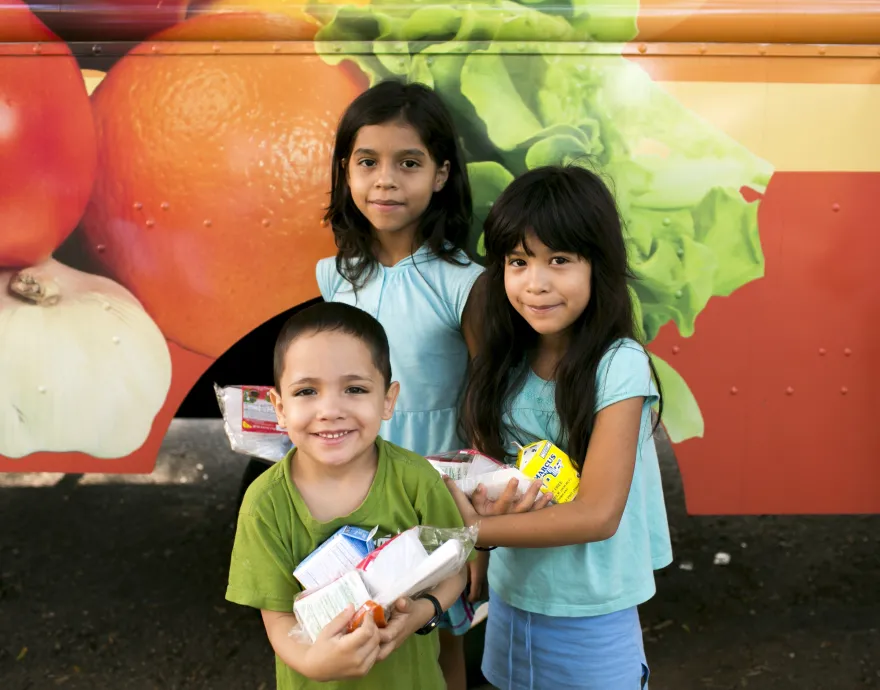 Kids at a free summer meals truck.