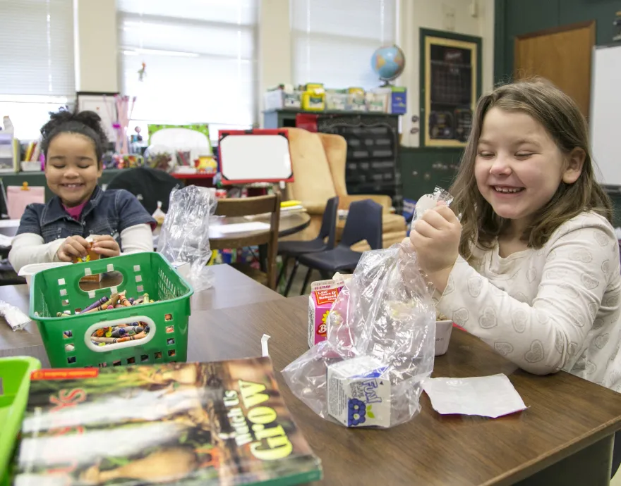 girls eating breakfast in their classroom