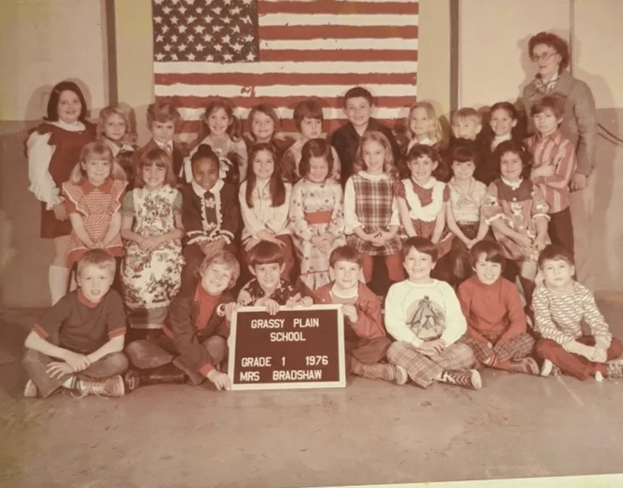 School picture of group of white kids with one Black kid