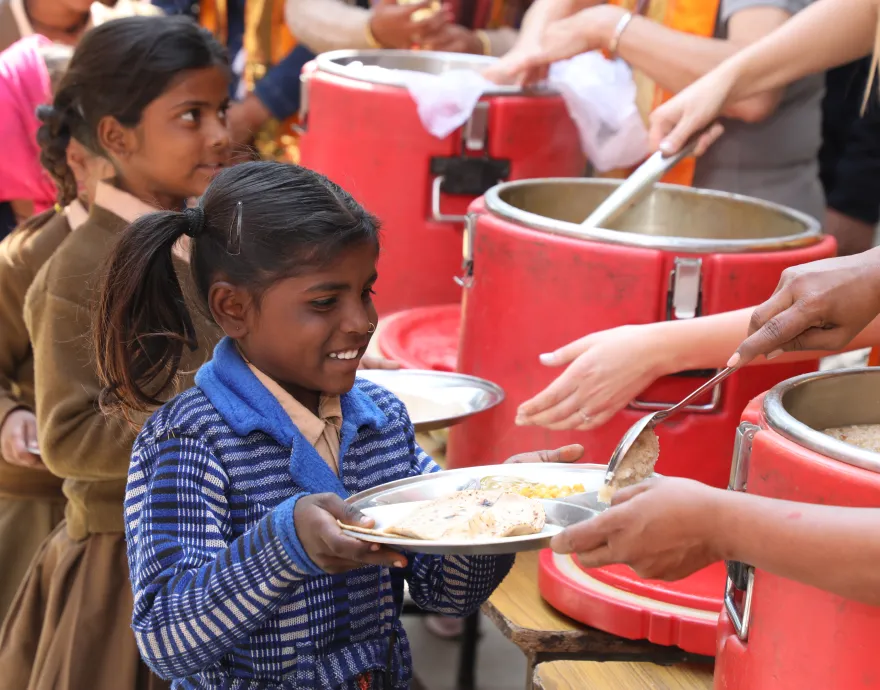 Girl picking up meal in India