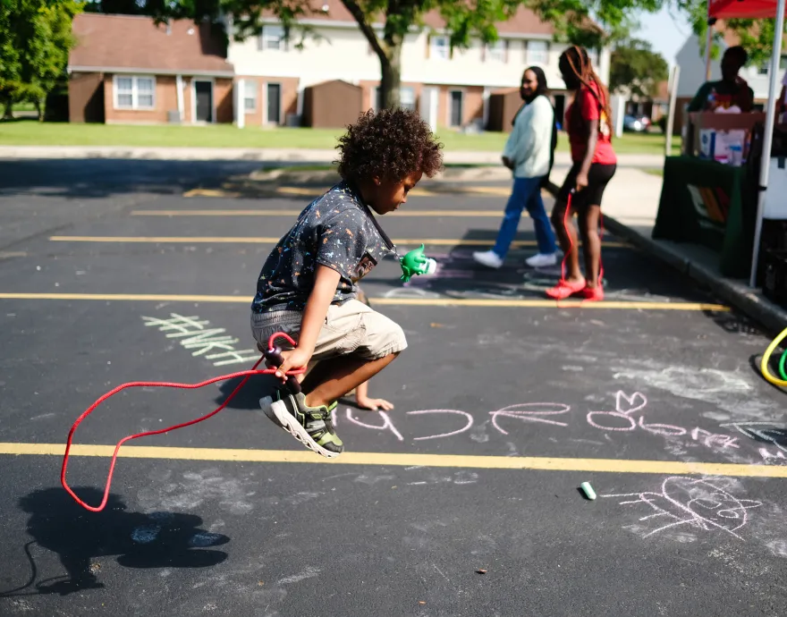 Kid jumping rope at a summer meal site.