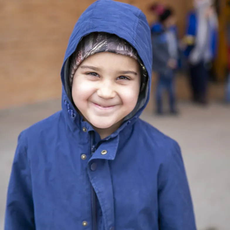 young boy wearing a coat