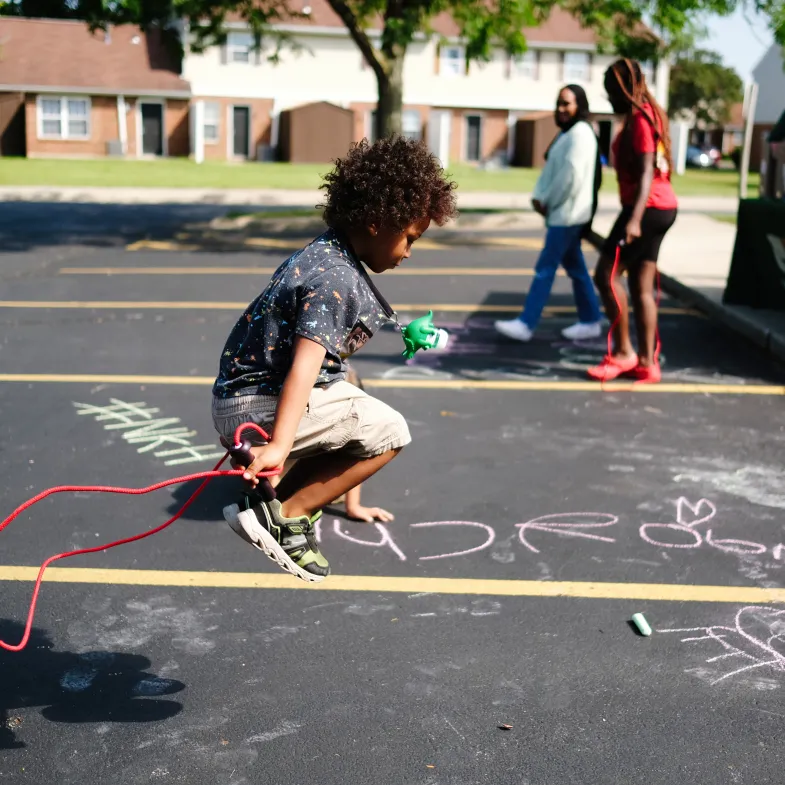 Kid jumping rope at a summer meal site.