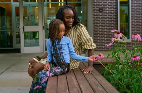 Mom and girl looking at flowers