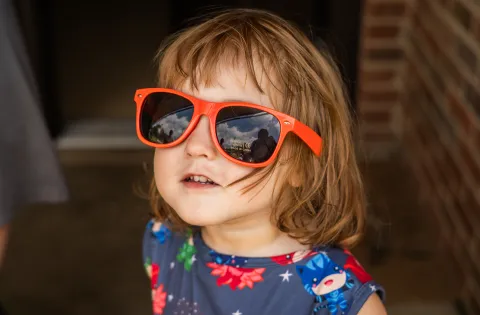 White girl with orange sunglasses