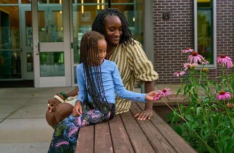 Woman and child looking at flowers